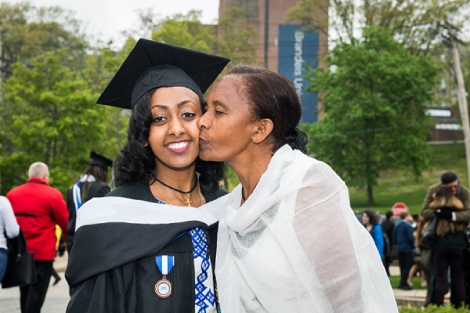 Roza's Mom kisses her on the cheek